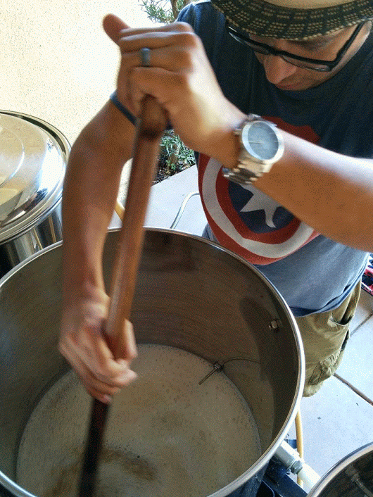 Stirring the Mash Tun While Making Home Brewed Beer